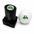 A black Golf Cart Golf Ball Stamp with quick-dry ink and a green golf cart design sits beside a white ball stamped with the same image, making ball identification easy—an ideal fun gift for fans of personalized golf gear.