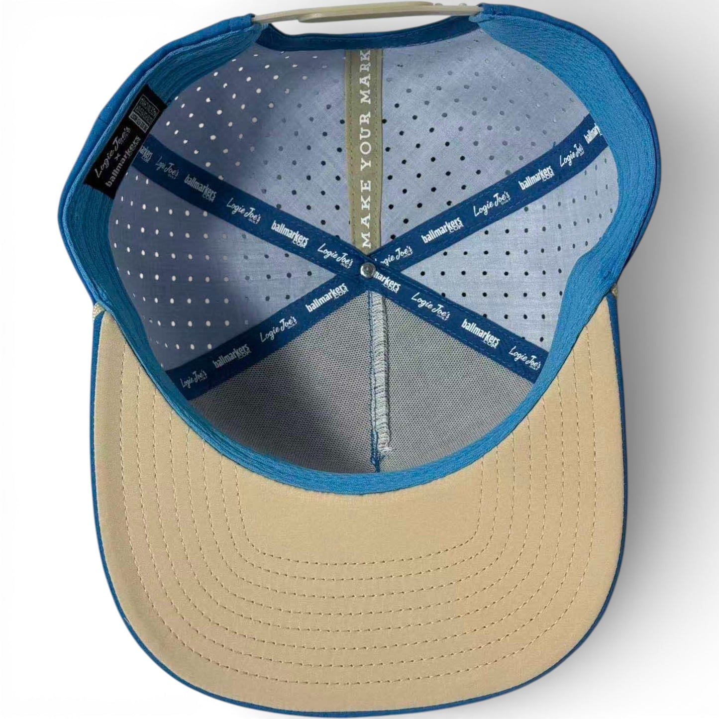Top-down view inside the blue and beige Fairway Palms Golf Hat Snapback Cap, showing Imperial Headwear, Lopez Steers branding, ventilation holes, MAKE YOUR MARK strip, and built-in magnetic ball marker holder with included marker.
