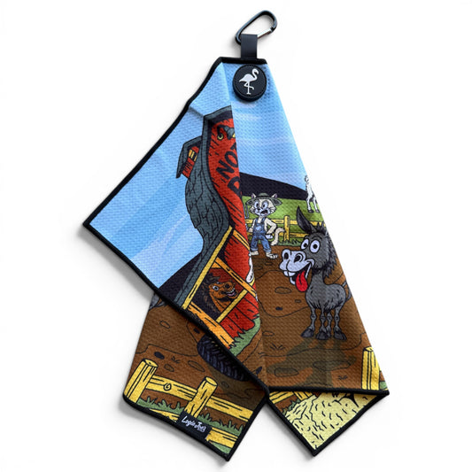The Back Nine Barnyard Golf Towel (24” x 16”) features cartoon barnyard art, black edges, a Loyal2You tag, and hangs by a magnetic clip and carabiner—making it a fun and premium microfiber golf accessory.