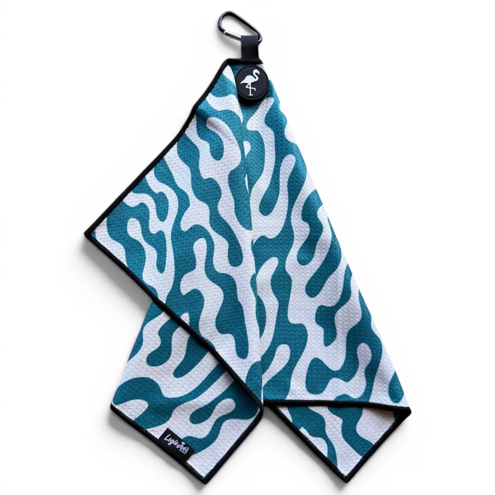 The Coral Bloom Golf Towel (24” x 16”) is a blue and white wavy camouflage-patterned microfiber towel with black trim, a magnetic clip, carabiner, and loop, shown on a white background.