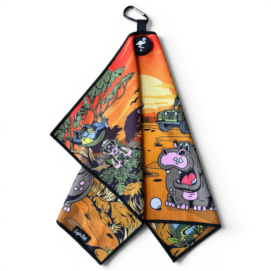 The Safari Expedition: Lost Fairway Golf Towel (24” x 16”) features colorful safari animals—a hippo with a heart, monkey, birds, and jeep on the savanna. Includes a black border plus magnetic clip & carabiner for easy hanging—premium golf accessory!.