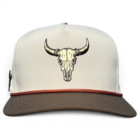 The Longhorn Golf Hat is a cream snapback cap with a brown brim and tan bull skull graphic, featuring an adjustable fit and built-in magnetic ball marker holder—marker included—making it perfect for your golf game.