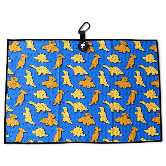 The Blue Dino Chicken Nugget Golf Towel is a 24”x16” microfiber towel with yellow and orange cartoon dinosaurs, black border, hanging loop, round black tag, plus a magnetic clip and carabiner.