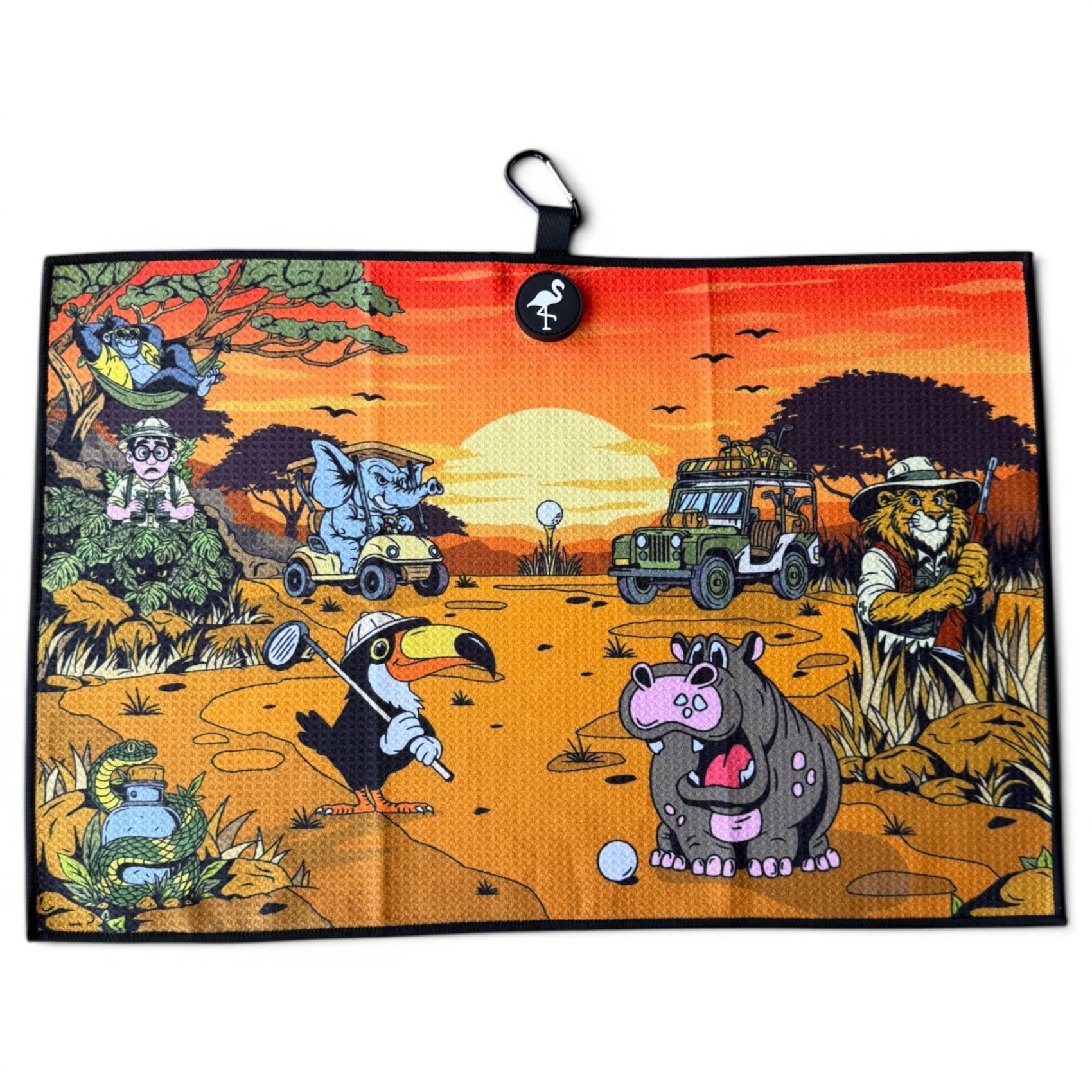 A cartoon golf scene on an African savanna at sunset shows a lion, elephant, toucan, and hippo golfing with the Safari Expedition: Lost Fairway Golf Towel nearby, plus a jeep and trees in the background.