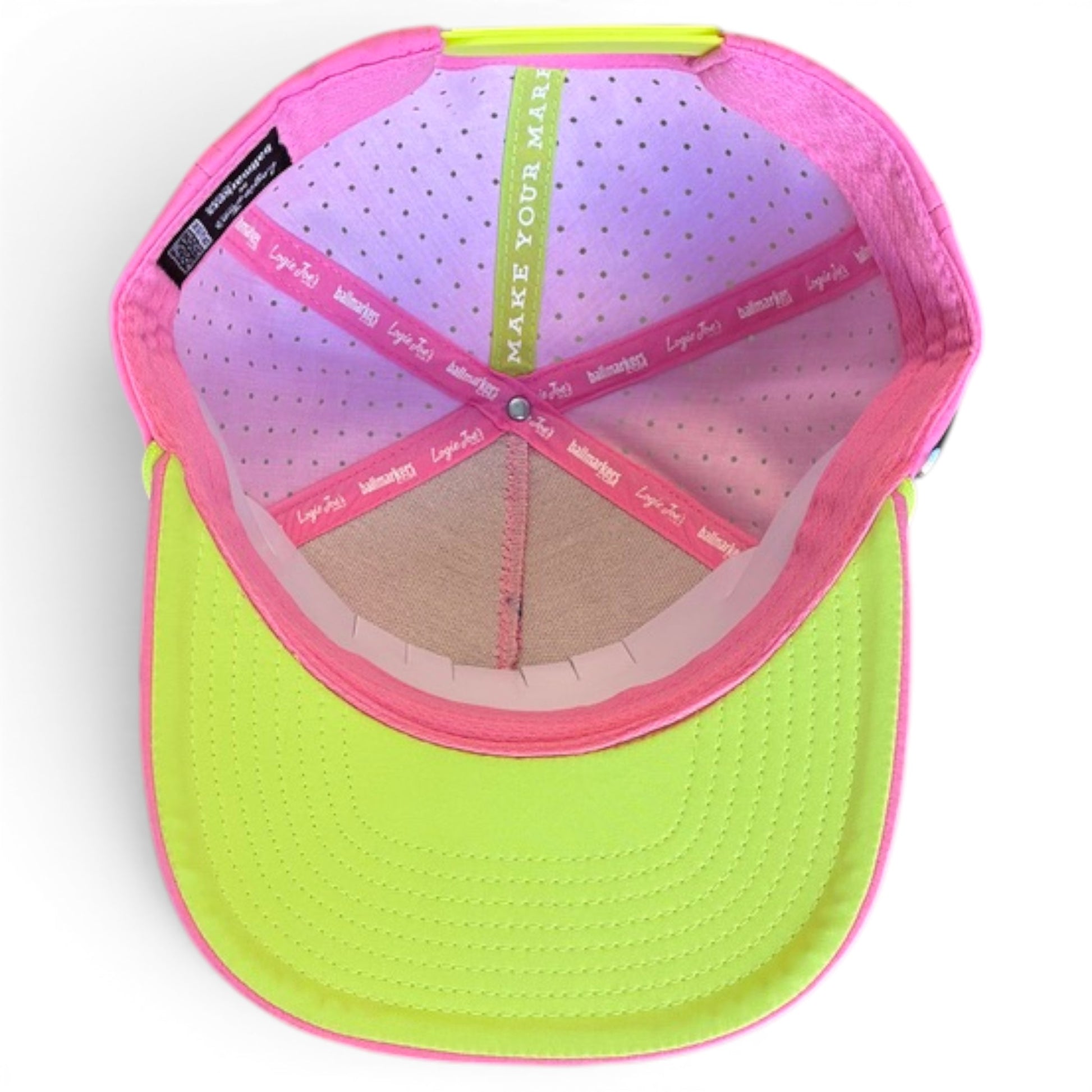 The image shows the inside of the Coconut Cocktail Golf Hat, a bright yellow adjustable snapback cap with a pink rim, built-in magnetic ball marker holder with marker included, and colorful inner bands reading "MAKE YOUR MARK.