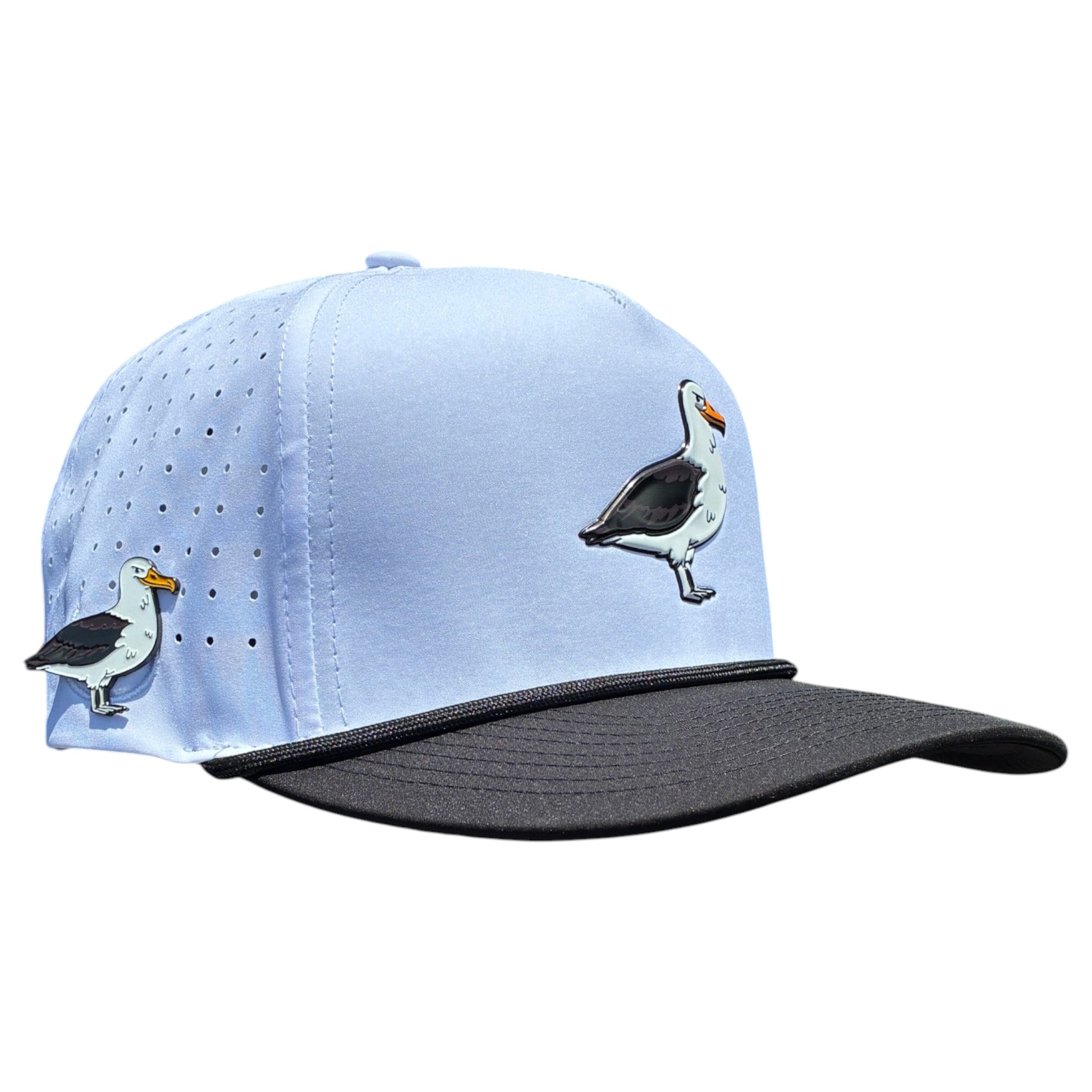 The Albatross Golf Hat is a light blue adjustable snapback cap with a black bill, embroidered seagull images, ventilation holes, and a built-in magnetic ball marker holder with marker included.