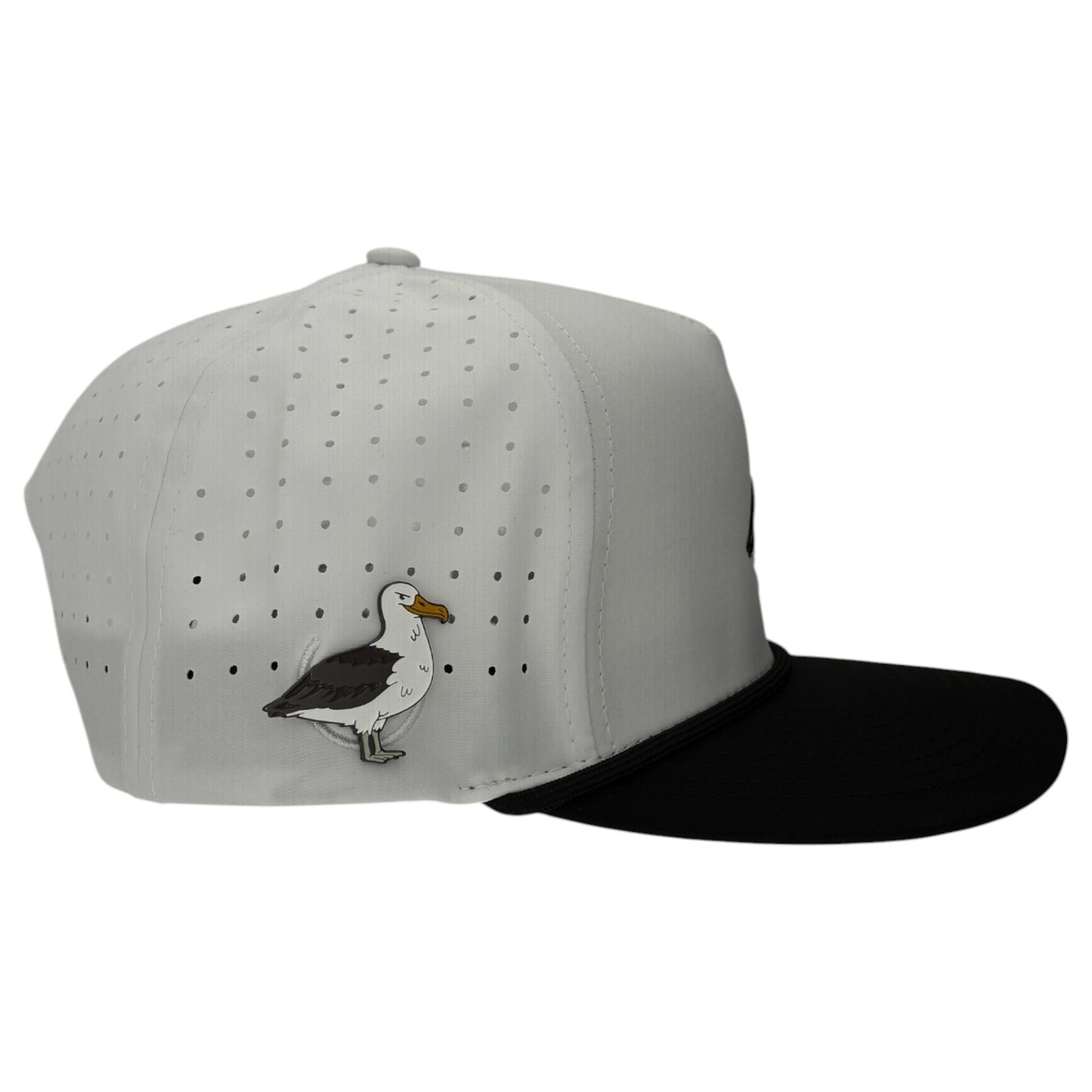 The Albatross Golf Hat is a stylish white and black snapback cap with a built-in magnetic ball marker holder and included marker. It features small perforations, an embroidered bird, and an adjustable fit—perfect for any round.