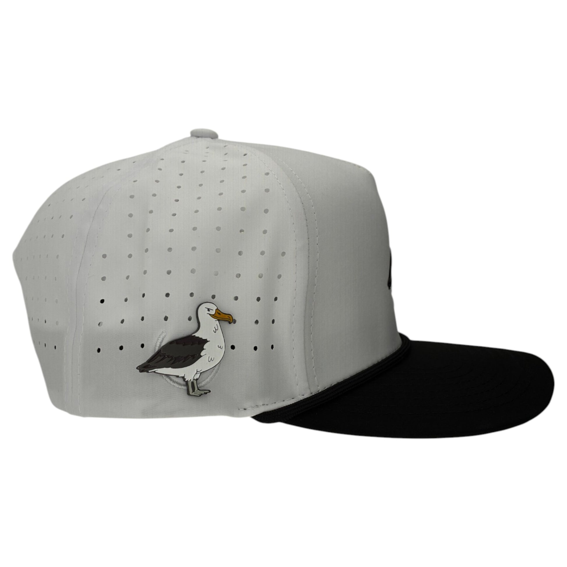 The Albatross Golf Hat is a stylish white and black snapback cap with a built-in magnetic ball marker holder and included marker. It features small perforations, an embroidered bird, and an adjustable fit—perfect for any round.