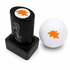 A Dino Chicken Nugget Golf Ball Stamp sits next to a white golf ball, both marked with a fun dino nugget design—making for easy ball identification and a unique golf gift.