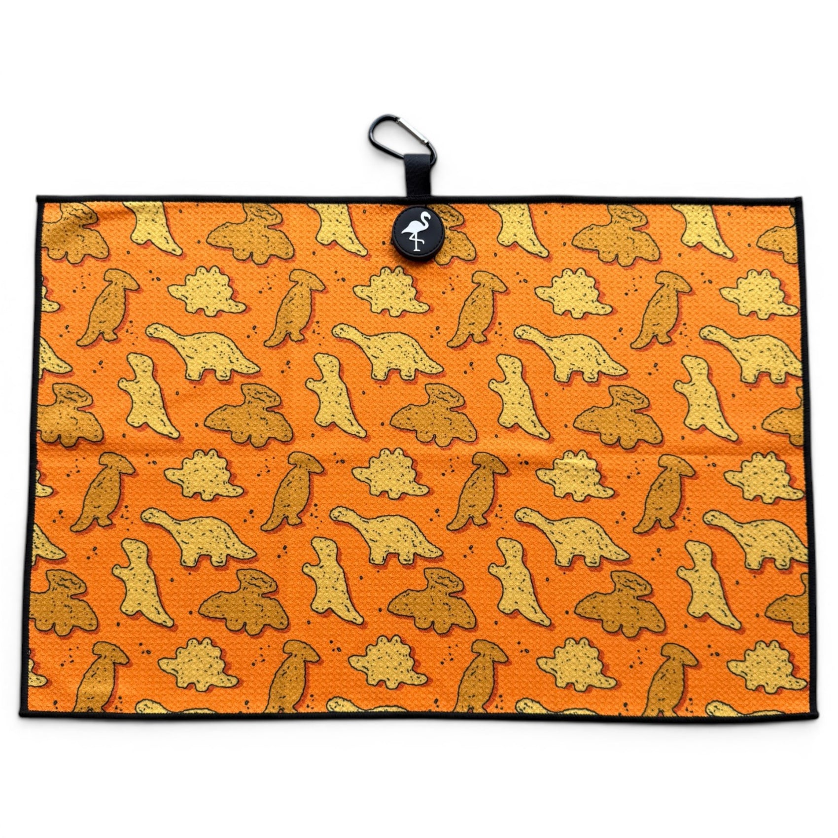 The Orange Dino Chicken Nugget Golf Towel (24” x 16”) is a microfiber golf towel with cartoon dinosaurs, cheese puffs, a magnetic clip, carabiner, black border, and circular tag—making it a premium golf accessory for any enthusiast.