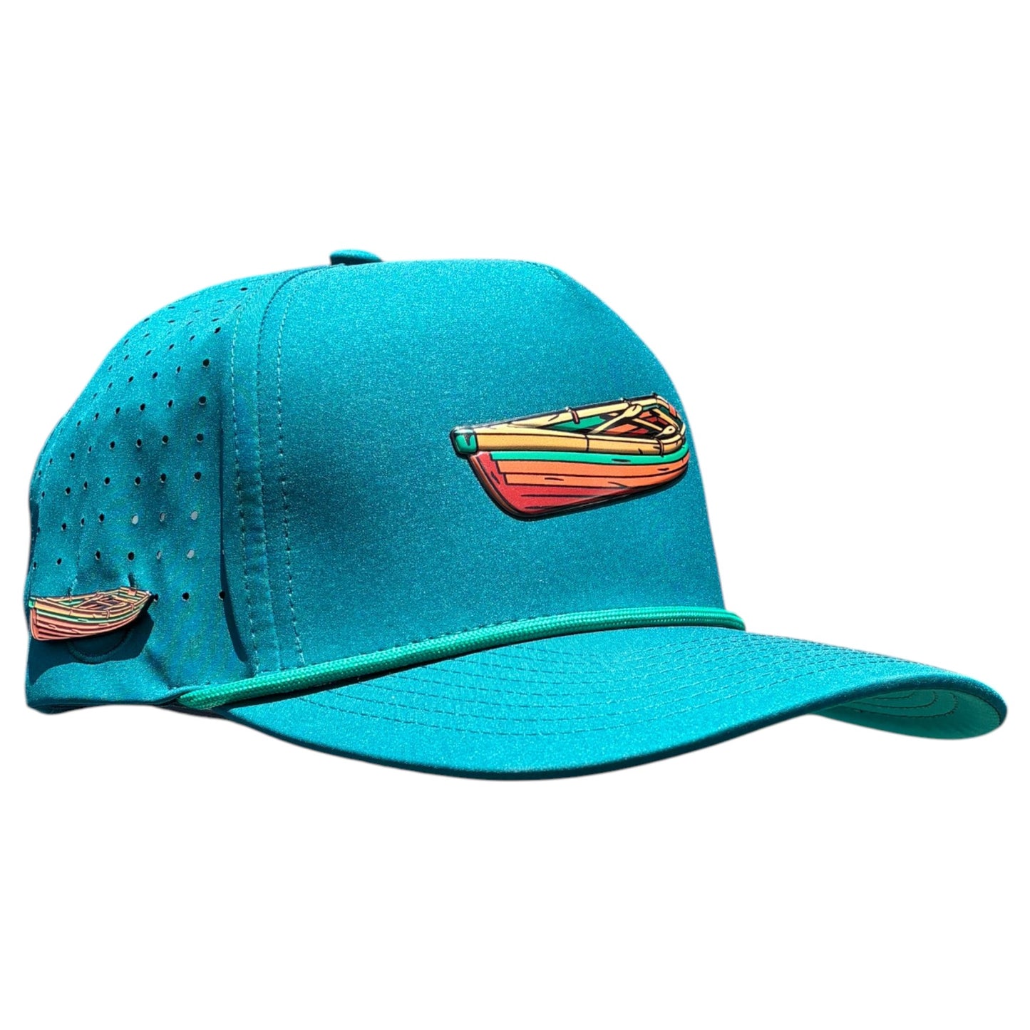 The Driftwood Golf Hat in Wood Boat Teal is an adjustable snapback cap with a built-in magnetic ball marker holder (marker included), colorful kayak embroidery, ventilation holes, and a flat brim with green piping.