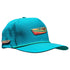 The Driftwood Golf Hat in Wood Boat Teal is an adjustable snapback cap with a built-in magnetic ball marker holder (marker included), colorful kayak embroidery, ventilation holes, and a flat brim with green piping.
