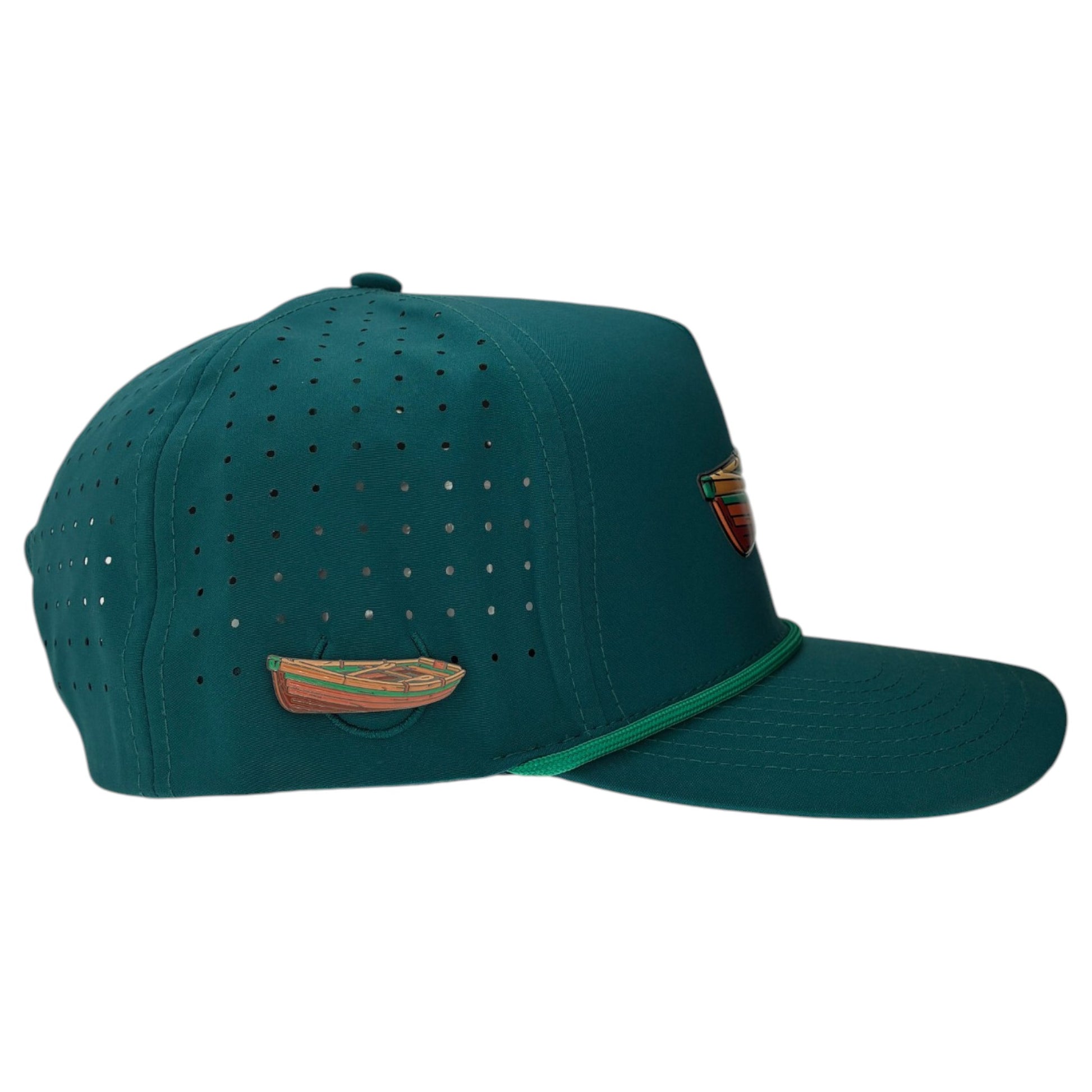 The Driftwood Golf Hat | Snapback Cap in Wood Boat Teal features ventilation holes, decorative canoe and shield patches, a curved brim with green trim, adjustable fit, and comes with a built-in magnetic ball marker holder plus marker included.