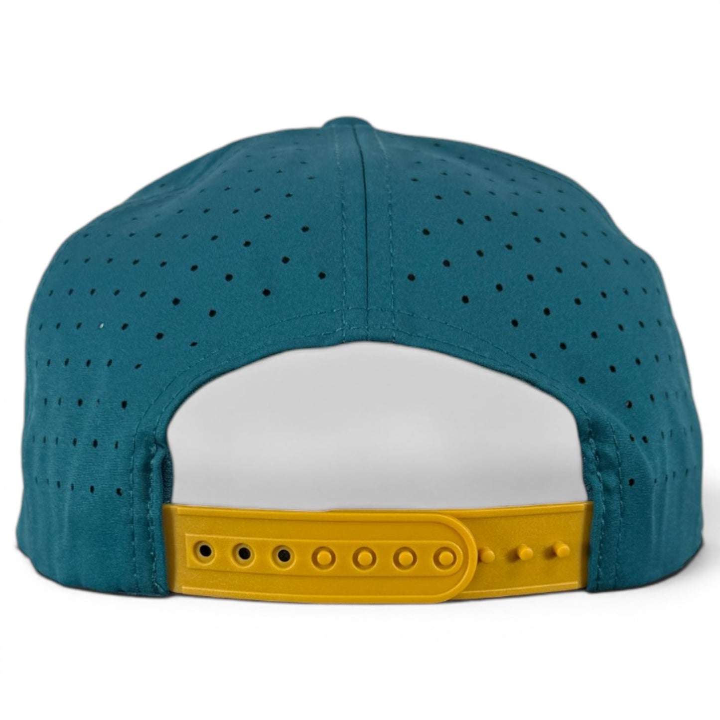 The image shows the Driftwood Golf Hat in Wood Boat Teal, an adjustable snapback cap with small ventilation holes and a built-in magnetic ball marker holder plus marker for convenience on the course.