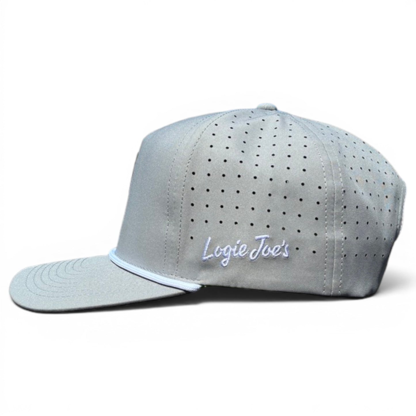 The Alien Caddy Golf Hat is a light gray snapback cap with ventilation holes, white Logic Joes script on the side, a flat brim, structured crown, and an adjustable fit. It features a built-in magnetic ball marker holder with marker included.