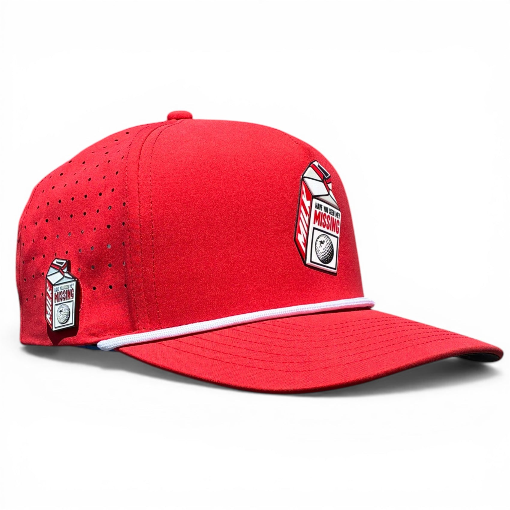 The Missing Milk Golf Hat is an adjustable red snapback cap with a built-in magnetic ball marker holder and included marker, featuring eyelets for ventilation and unique MISSING milk carton patches—an ideal accessory for golfers.
