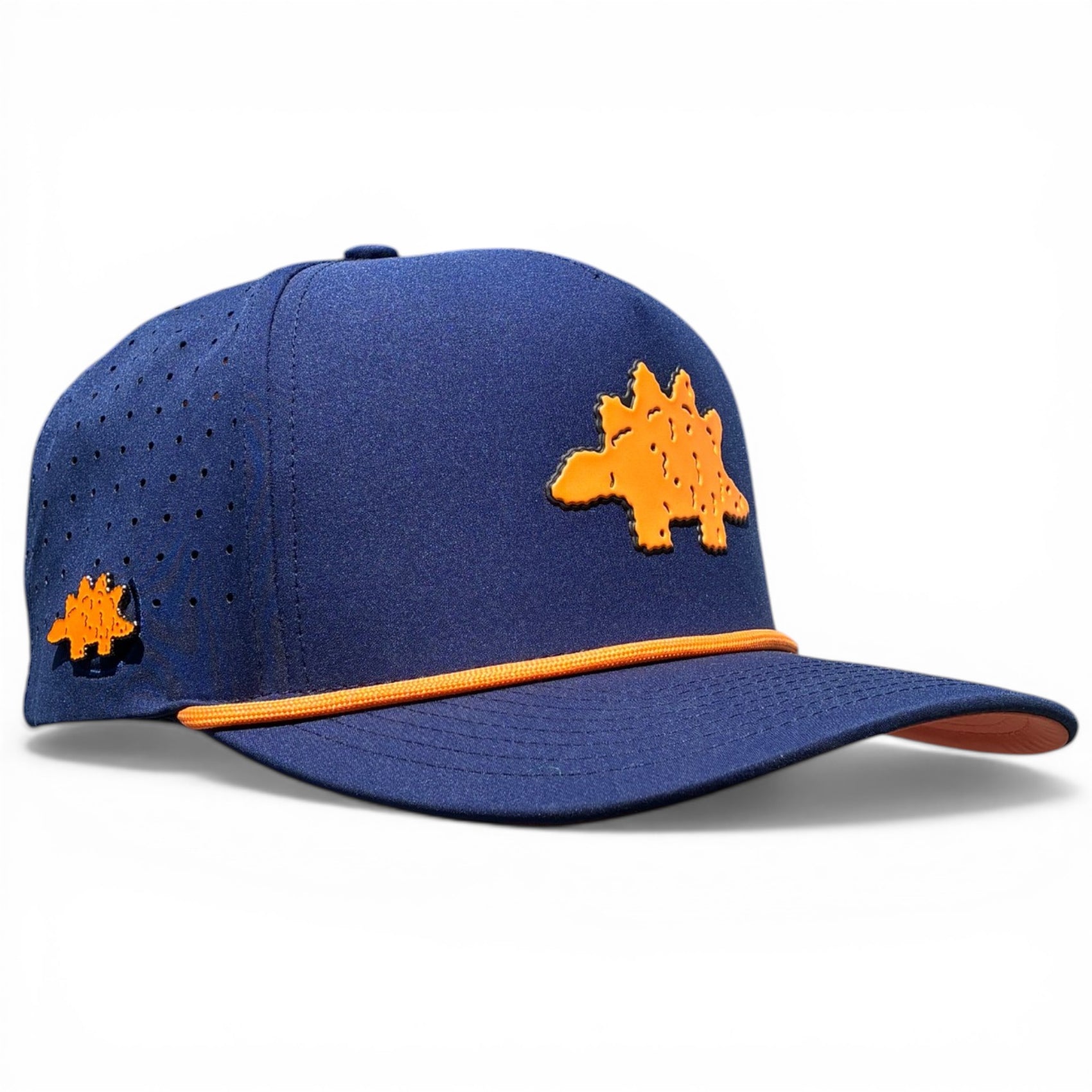 The Dino Nugget Golf Hat is a blue snapback cap with an orange stegosaurus patch, yellow brim trim, side ventilation holes, and features a built-in magnetic ball marker holder with marker included. Adjustable fit.