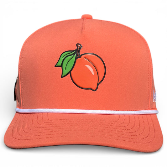 The Just Peachy Golf Hat is an adjustable orange snapback cap with a peach and green leaves graphic, white trim above the brim, and features a built-in magnetic ball marker holder with marker included.