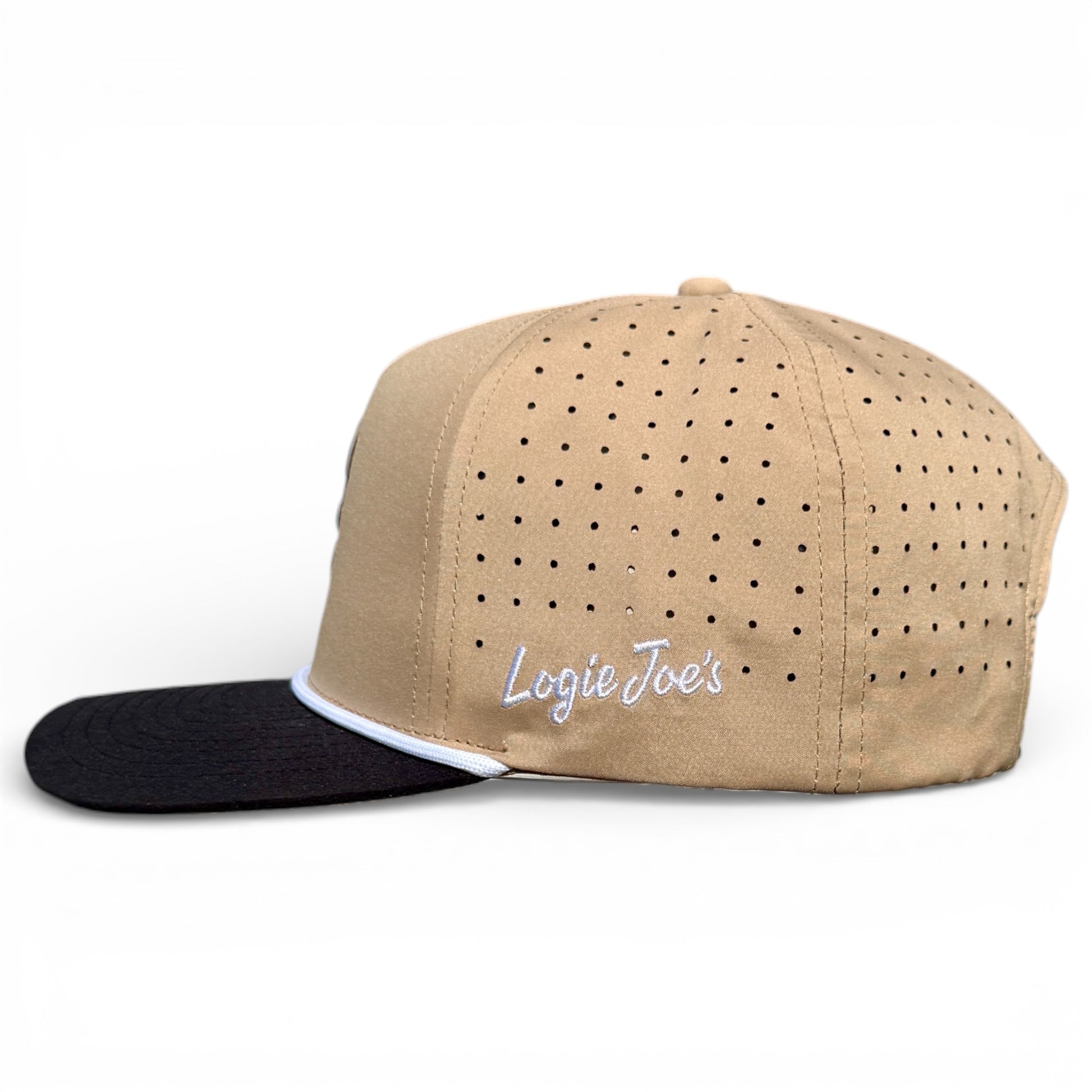 The Hunting Birdies Golf Hat is a tan and black adjustable snapback cap with ventilation holes, white “Logie Joes” embroidery, and a built-in magnetic ball marker holder plus marker—perfect for golfers.