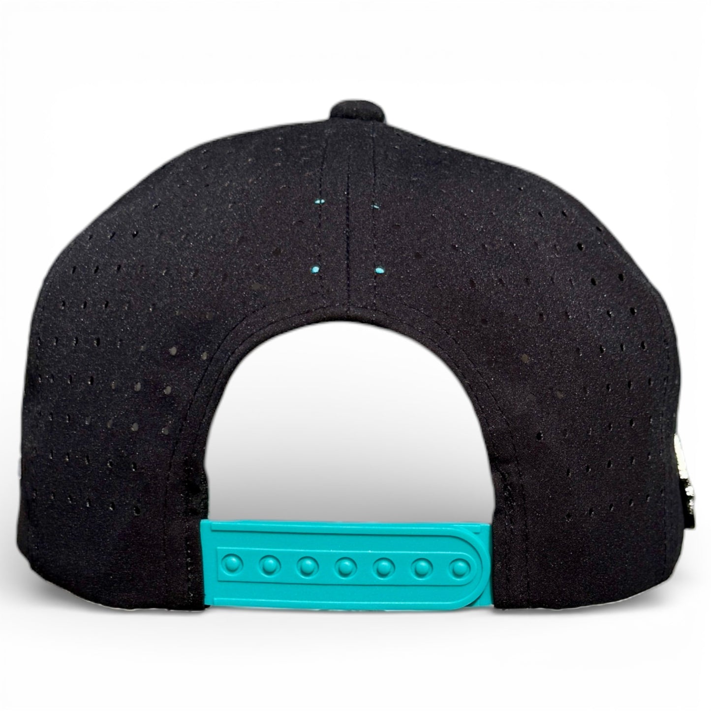 The image displays the back of a black Shark Bite Golf Hat snapback with teal adjustable strap, ventilation holes, and a built-in magnetic ball marker holder. The background is plain white.