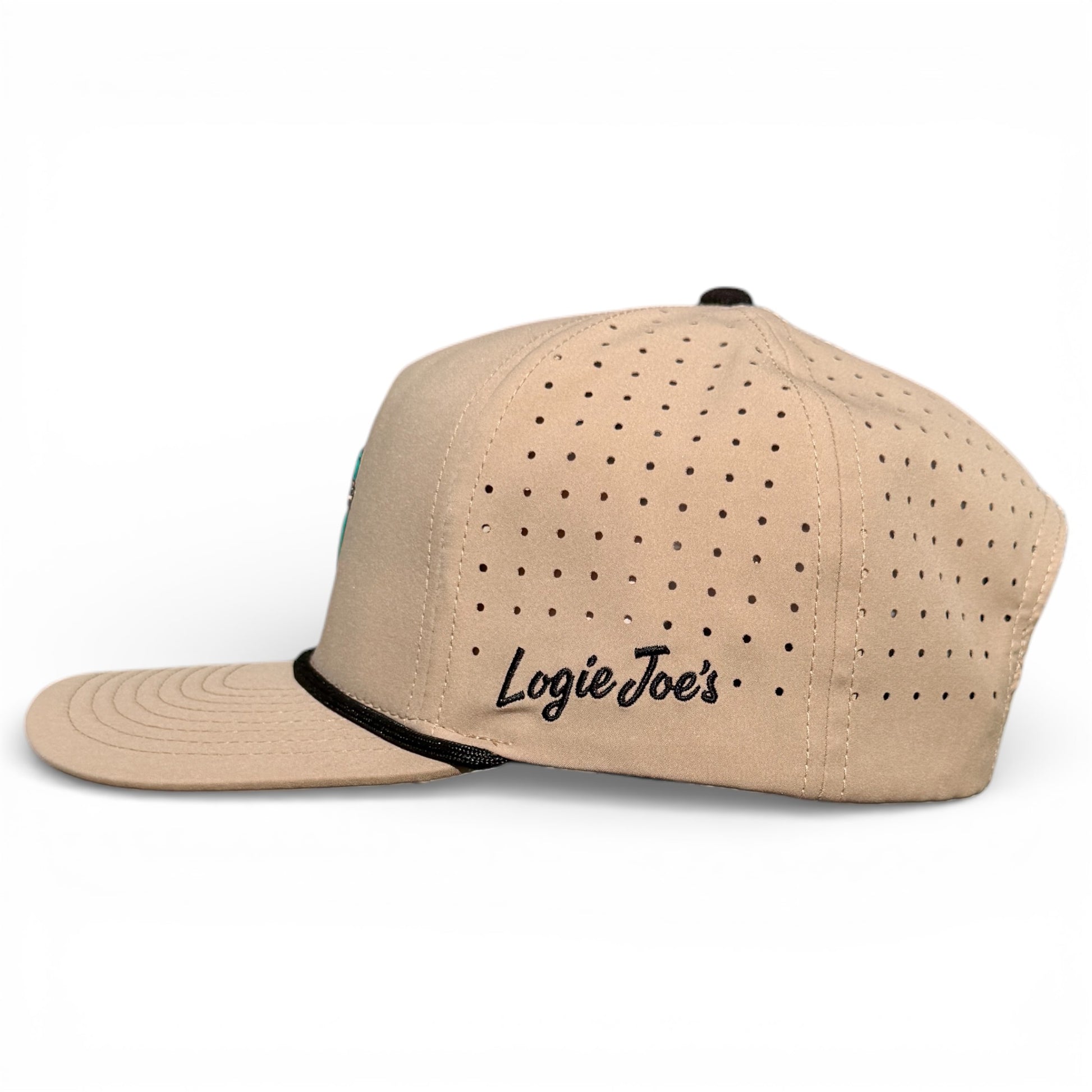 The Salty Turtle Golf Hat is a beige snapback cap with black side perforations, a black top button, and “Logie Joe’s” in black script. It features an adjustable fit and includes a built-in magnetic ball marker holder plus marker. Displayed on white.