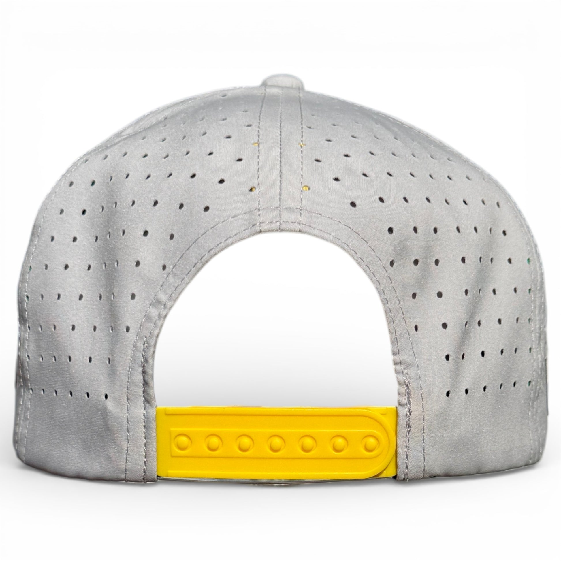 The image displays the back of a gray Banana Hammock Golf Hat featuring perforations and a yellow adjustable snapback. This one-size cap includes a built-in magnetic ball marker holder with marker. The hat is set against a white background.