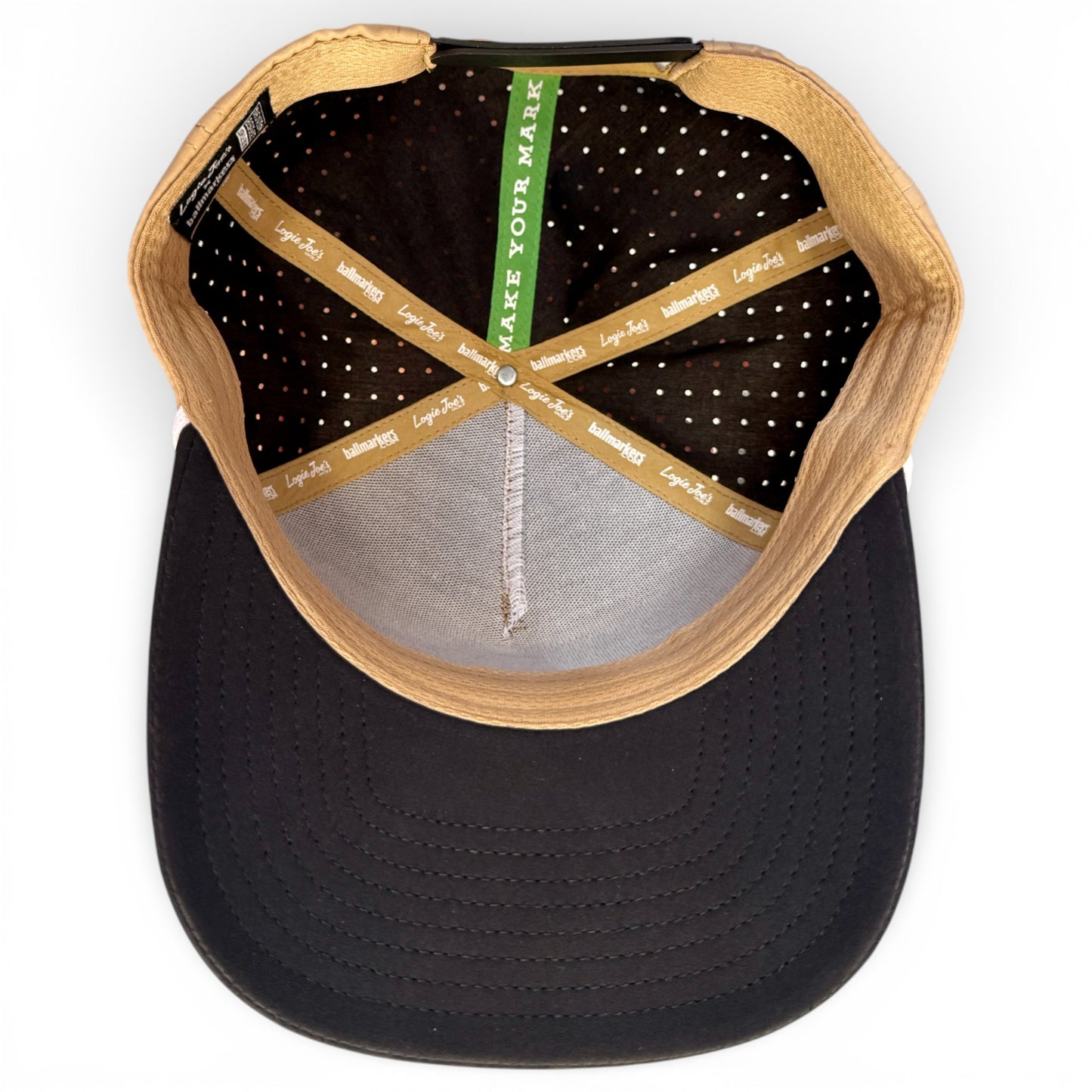 A top-down view of the Hunting Birdies Golf Hat | Snapback Cap in tan and black shows inner seams labeled MAKE YOUR MARK and Legit Aid, plus a curved brim with a built-in magnetic ball marker holder and included marker for style and function.