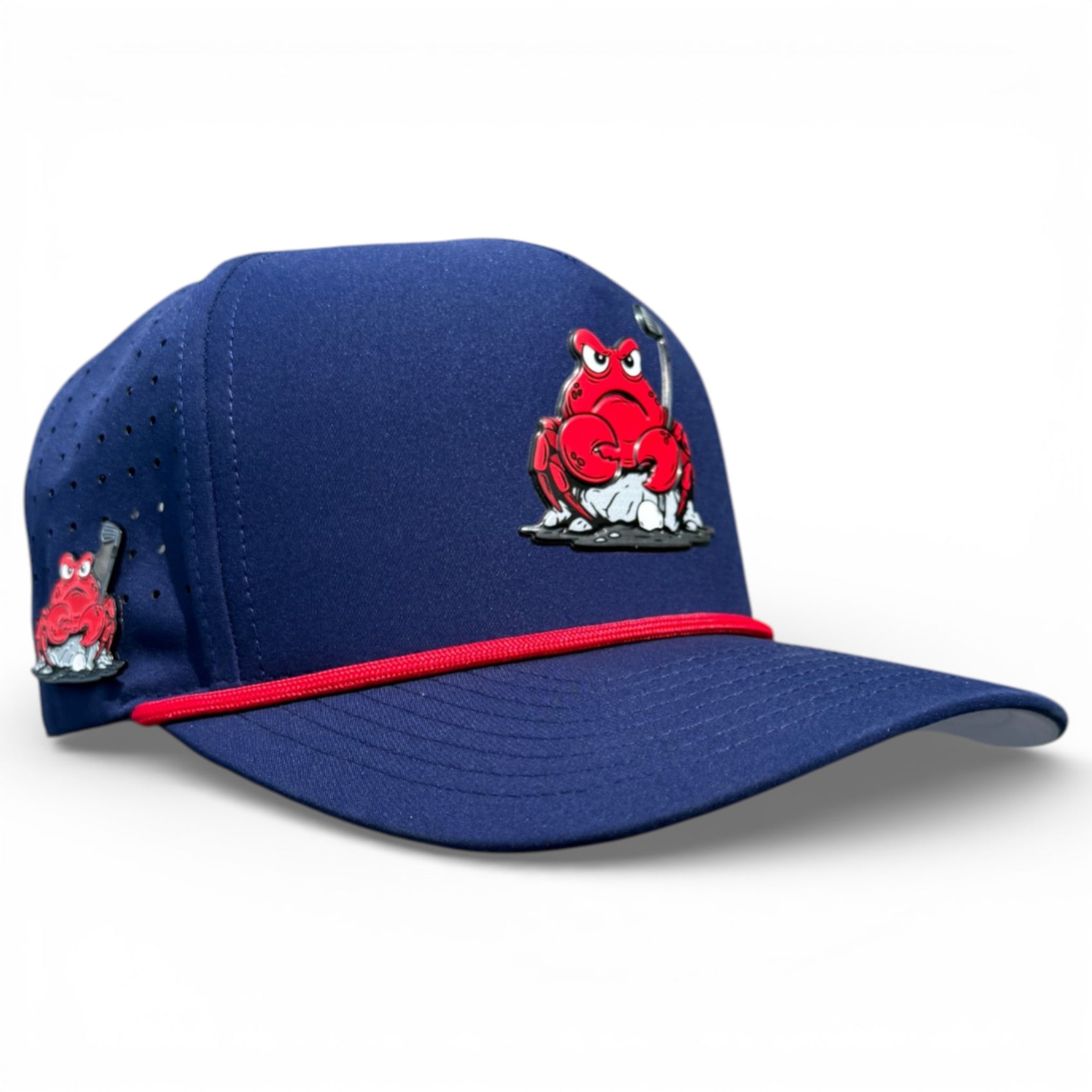 The Crab Trap Golf Hat is a blue adjustable snapback cap with a cartoon red crab holding a hockey stick on the front, red trim, perforated side panels, and features a built-in magnetic ball marker holder with marker included.