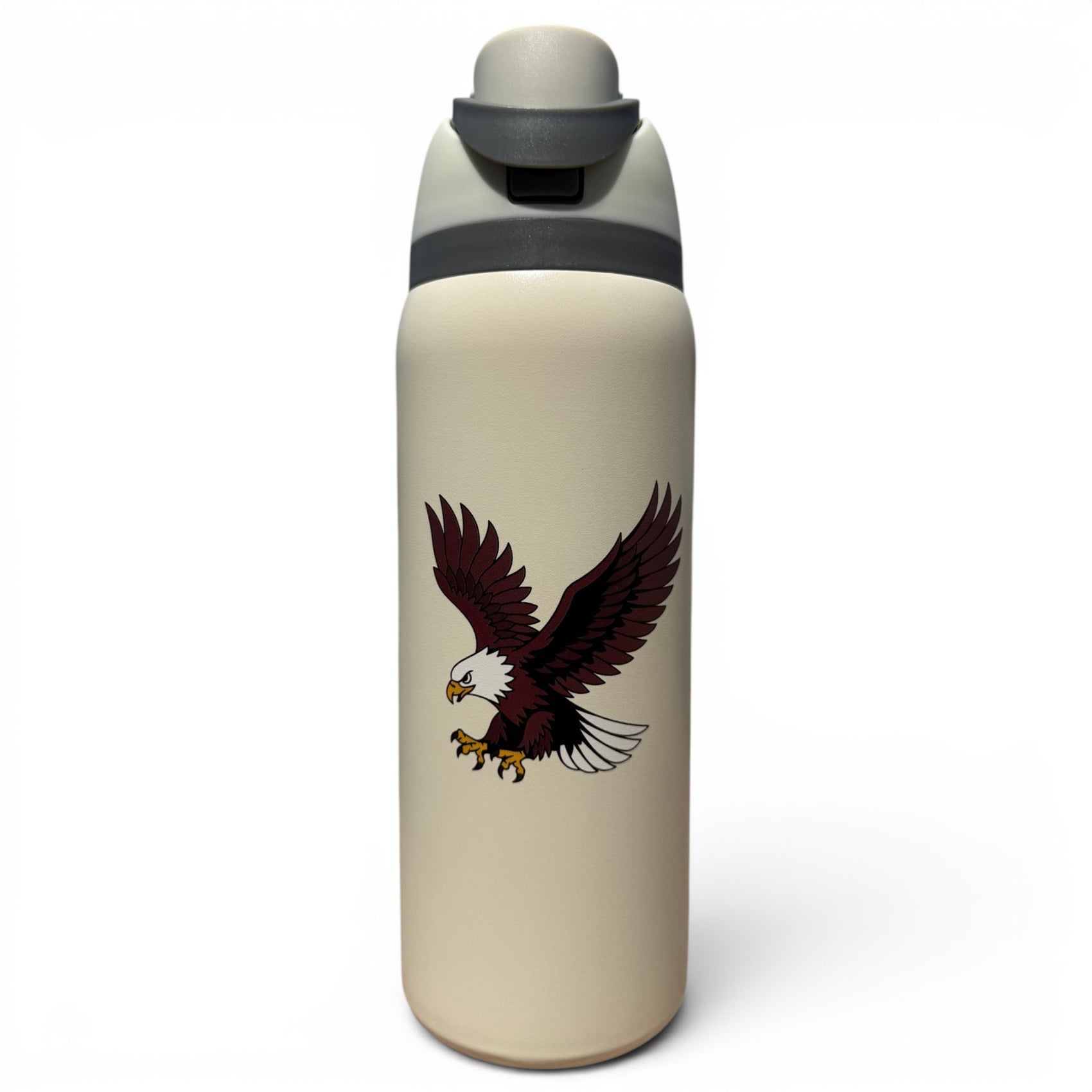 The Hydration Bottle – Eagle is a 32oz insulated stainless steel bottle in beige with a gray flip straw lid and handle, featuring a bold bald eagle with outstretched wings and extended talons on its side.