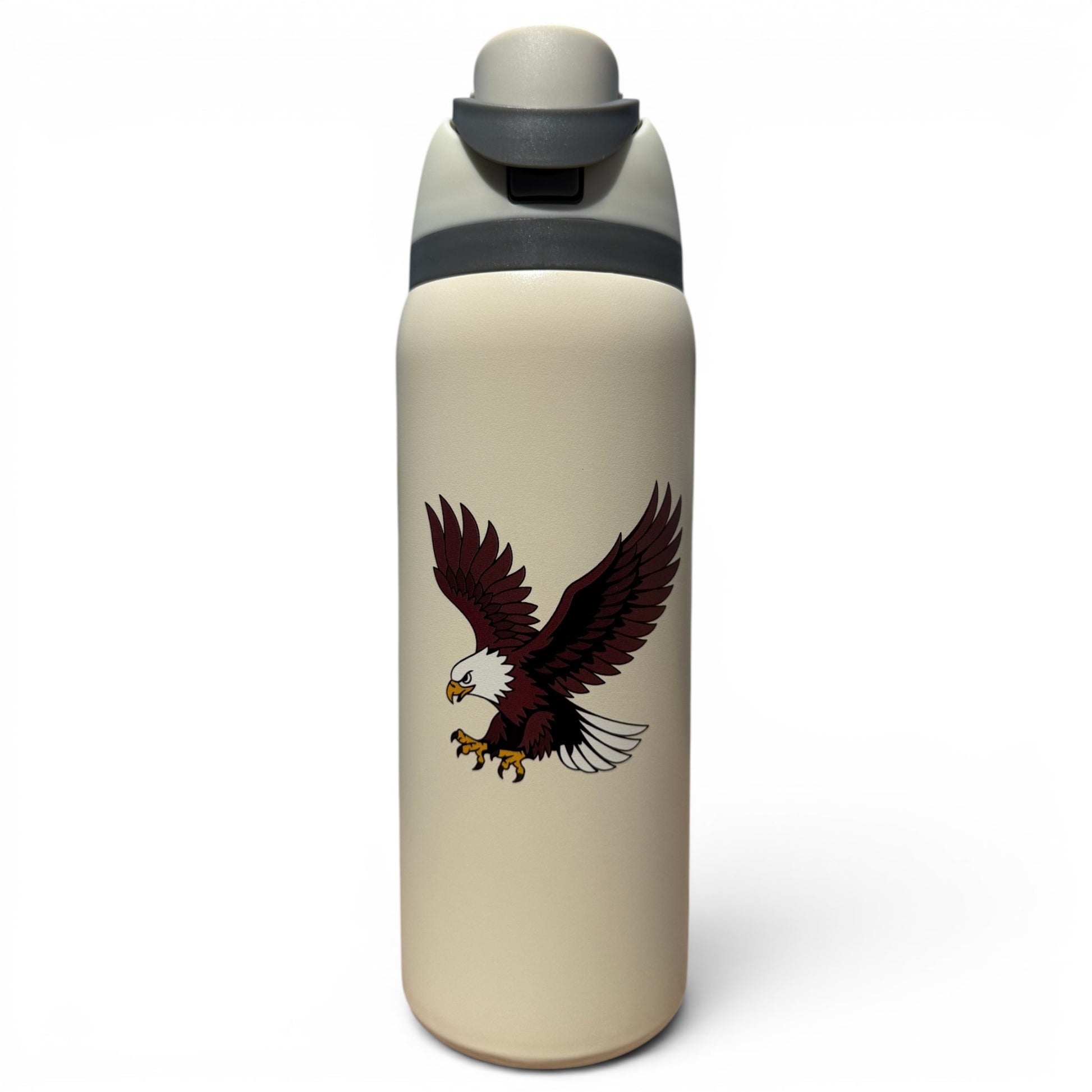 The Hydration Bottle – Eagle is a 32oz insulated stainless steel bottle in beige with a gray flip straw lid and handle, featuring a bold bald eagle with outstretched wings and extended talons on its side.