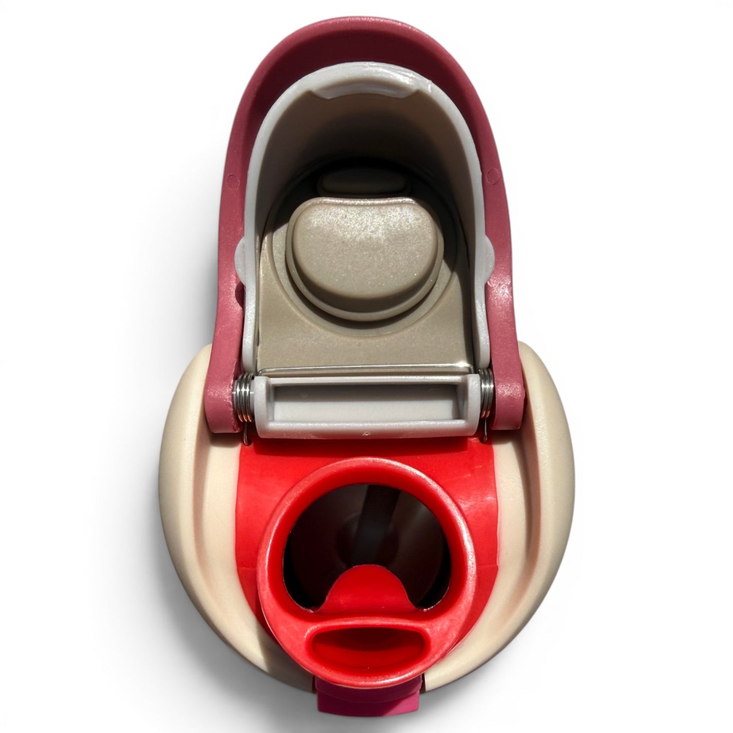 A close-up, top-down view of the Crab Trap 32oz Insulated Stainless Steel Hydration Bottle’s beige and red flip straw lid with handle, featuring a circular spout, set against a white background.