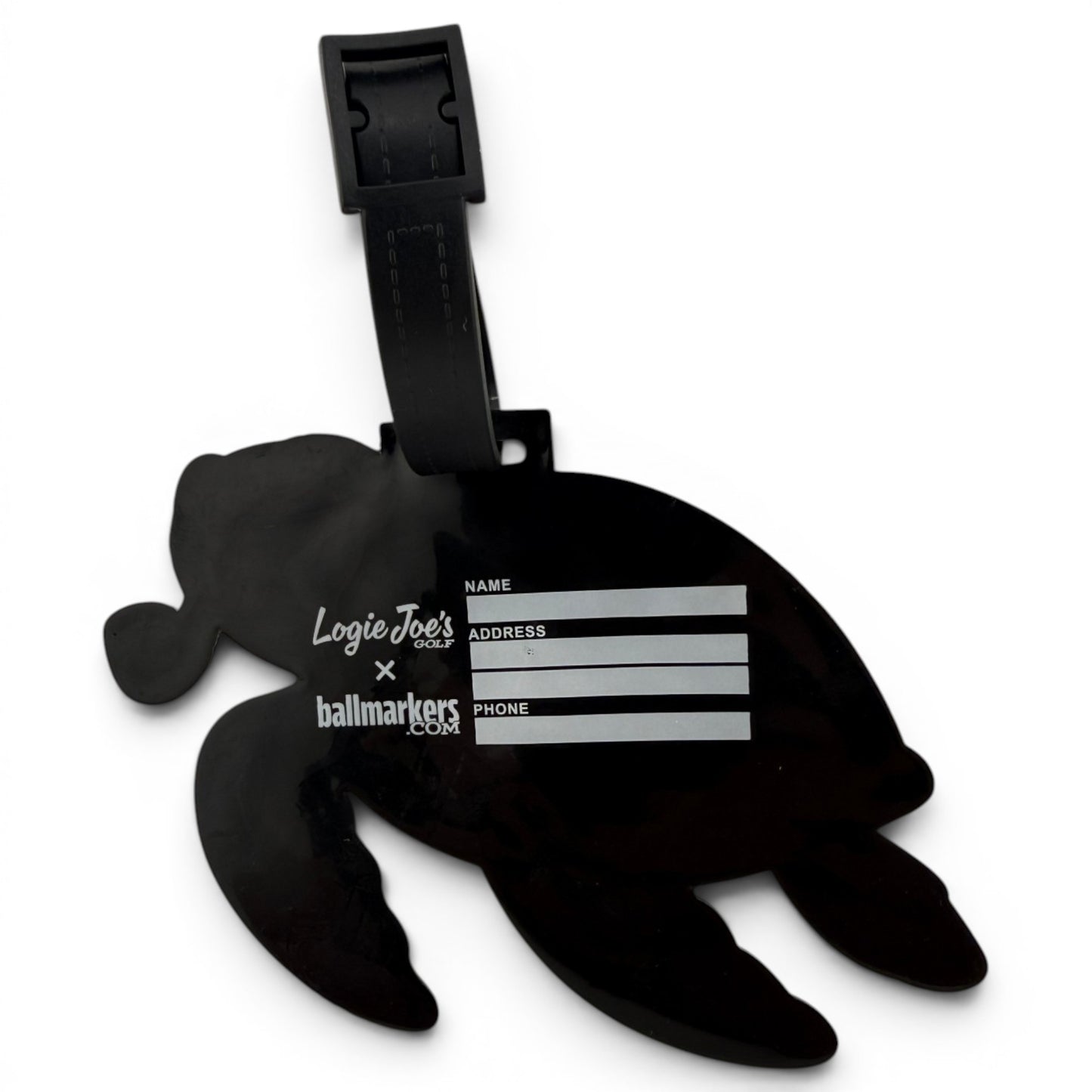 The Salty Turtle Clip-On Tag is a black turtle-shaped bag tag with a writable area for your info, sturdy strap, and white Logie Joes text. It’s ideal as a multi-use bag tag, travel tag, or unique golf accessory.