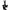 The Saturn Out Clip-On Tag is a black bag tag shaped like a cartoon character with outstretched arms and a hat. It features a strap, barcode-inspired white lines, and printed text on the front—ideal as a multi-use travel or golf accessory.