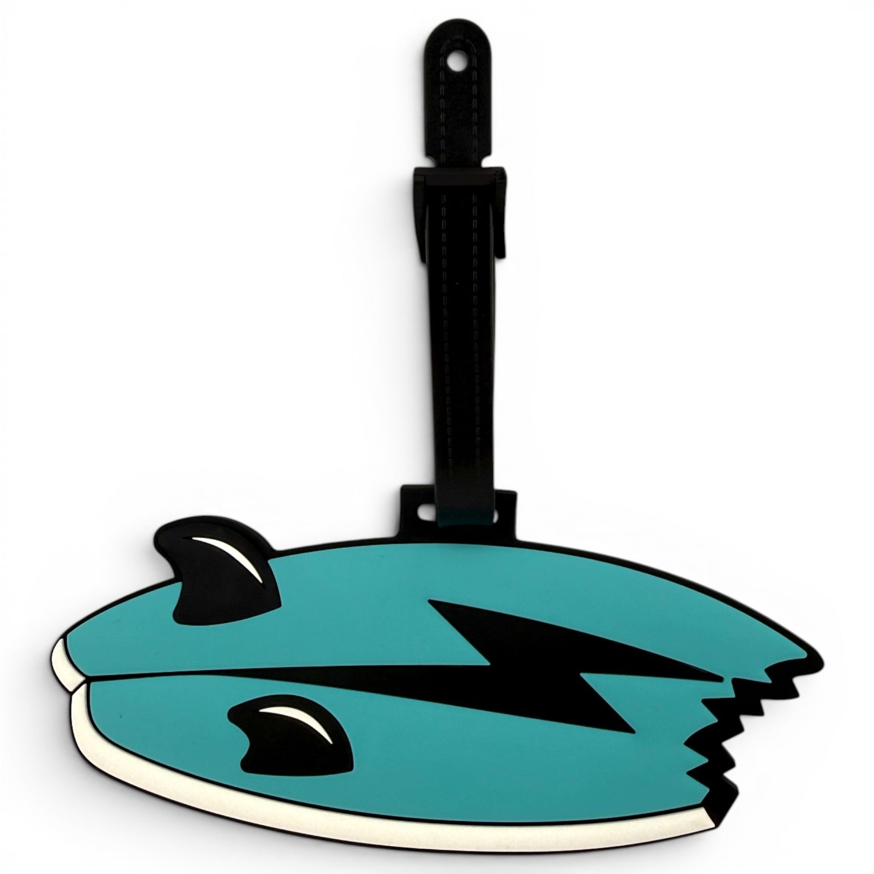 The Shark Bite Clip-On Tag is a teal, cartoon fish-shaped bag tag with a lightning bolt design, black fins, and a bite out of its tail. It includes a black strap—perfect as a travel tag or playful golf accessory.