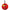 The Transfusion Golf Putting Disk is a round red keychain with a cartoon cocktail glass design featuring red liquid, ice, grapes, lime slice, and straw. Attached to a black clip, it’s a fun portable golf training aid. "Logic Joe’s" appears at the bottom.