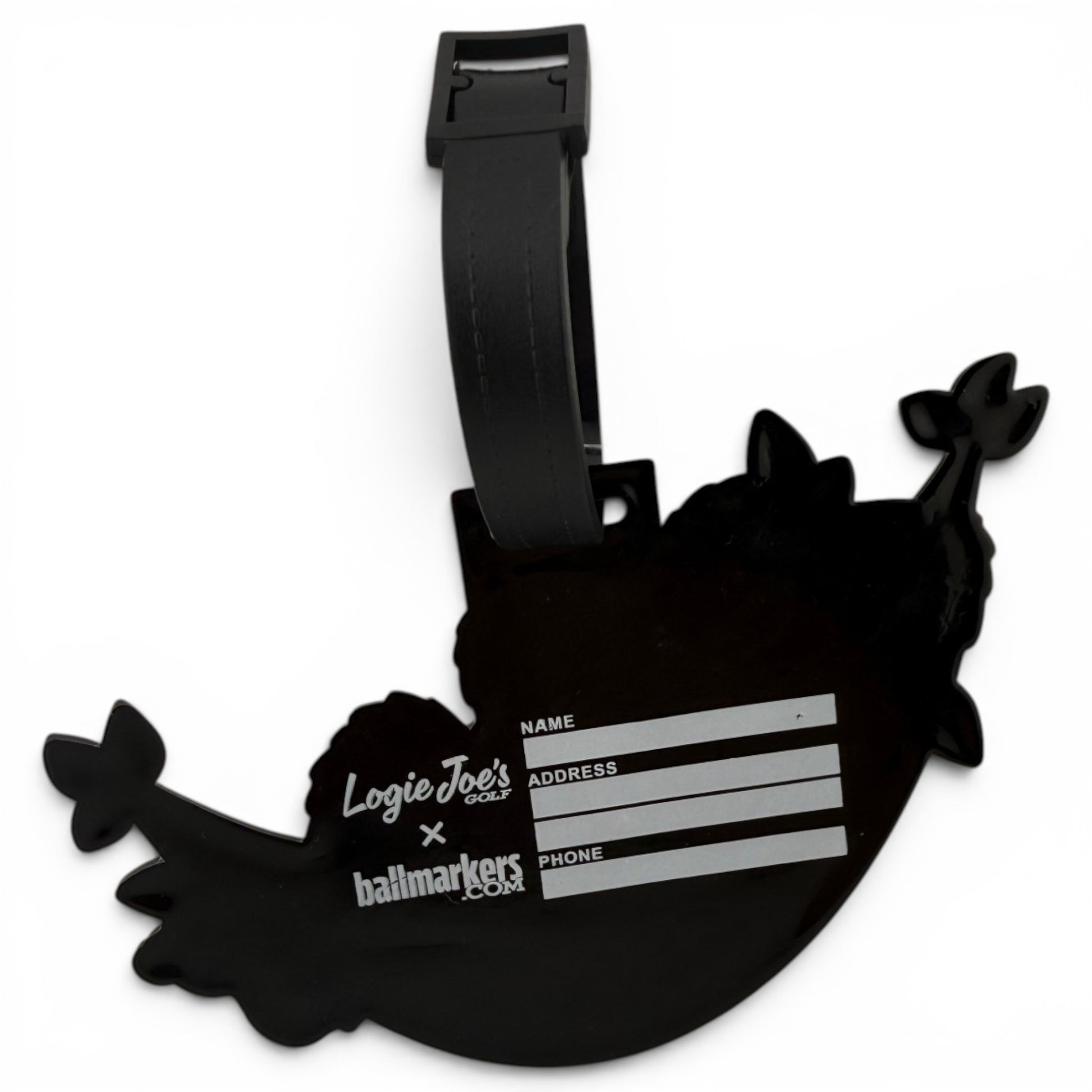 The Banana Hammock Clip-On Tag is a black narwhal-shaped bag tag with a strap, perfect for travel or golf bags. Includes fields for your name, address, and phone number, plus Logie Joes Golf and ballmarkers.com logos.