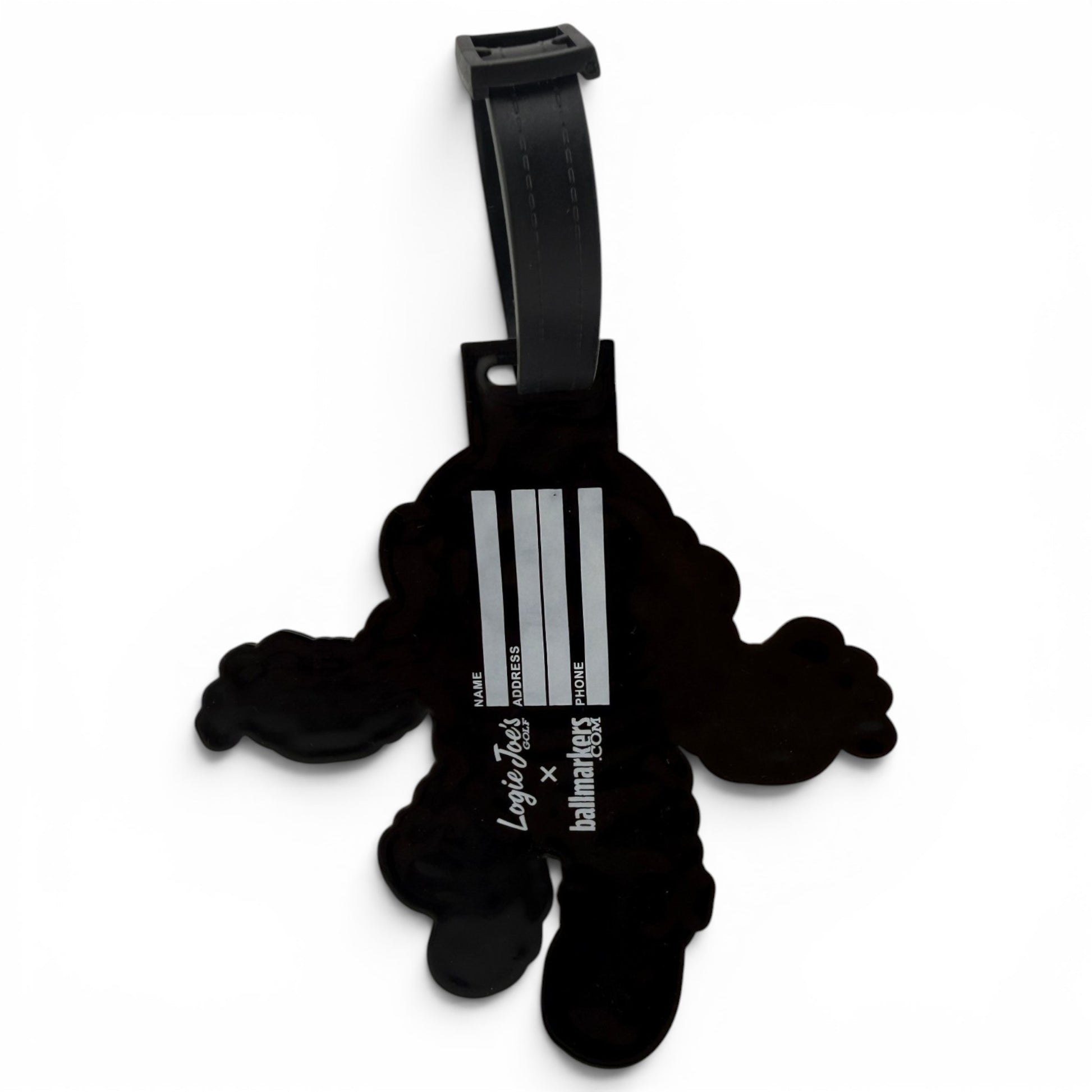 The Deep Dive Clip-On Tag is a black, cartoon-shaped bag tag with three silver stripes and “Luggage tag x balmainskies,” featuring a black strap for easy attachment to your travel or golf bag.