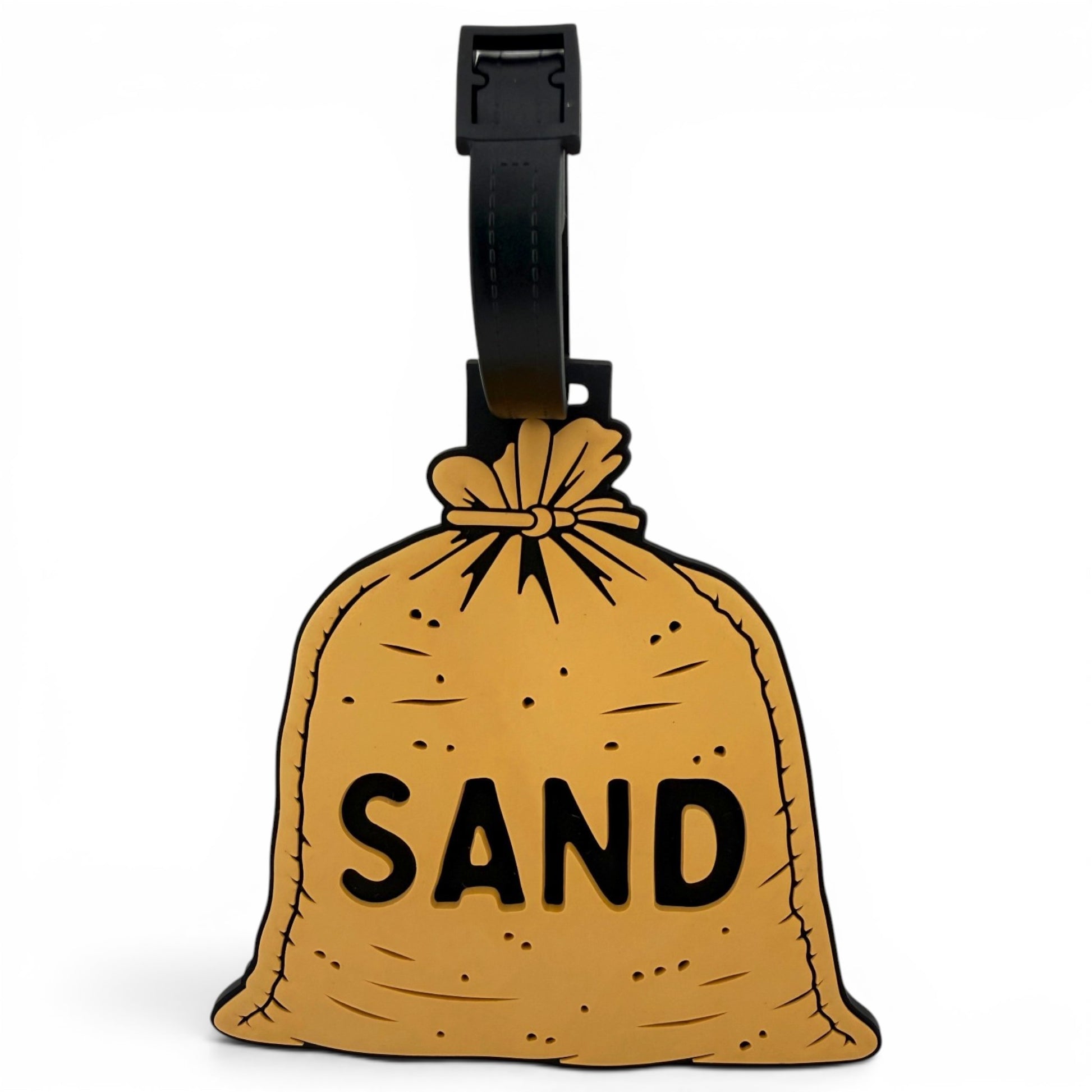 The Sand Bag Clip-On Tag is a brown sack-shaped travel tag with "SAND" in bold black letters and a black strap—perfect as a fun luggage tag or unique golf accessory.