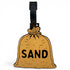 The Sand Bag Clip-On Tag is a brown sack-shaped travel tag with "SAND" in bold black letters and a black strap—perfect as a fun luggage tag or unique golf accessory.
