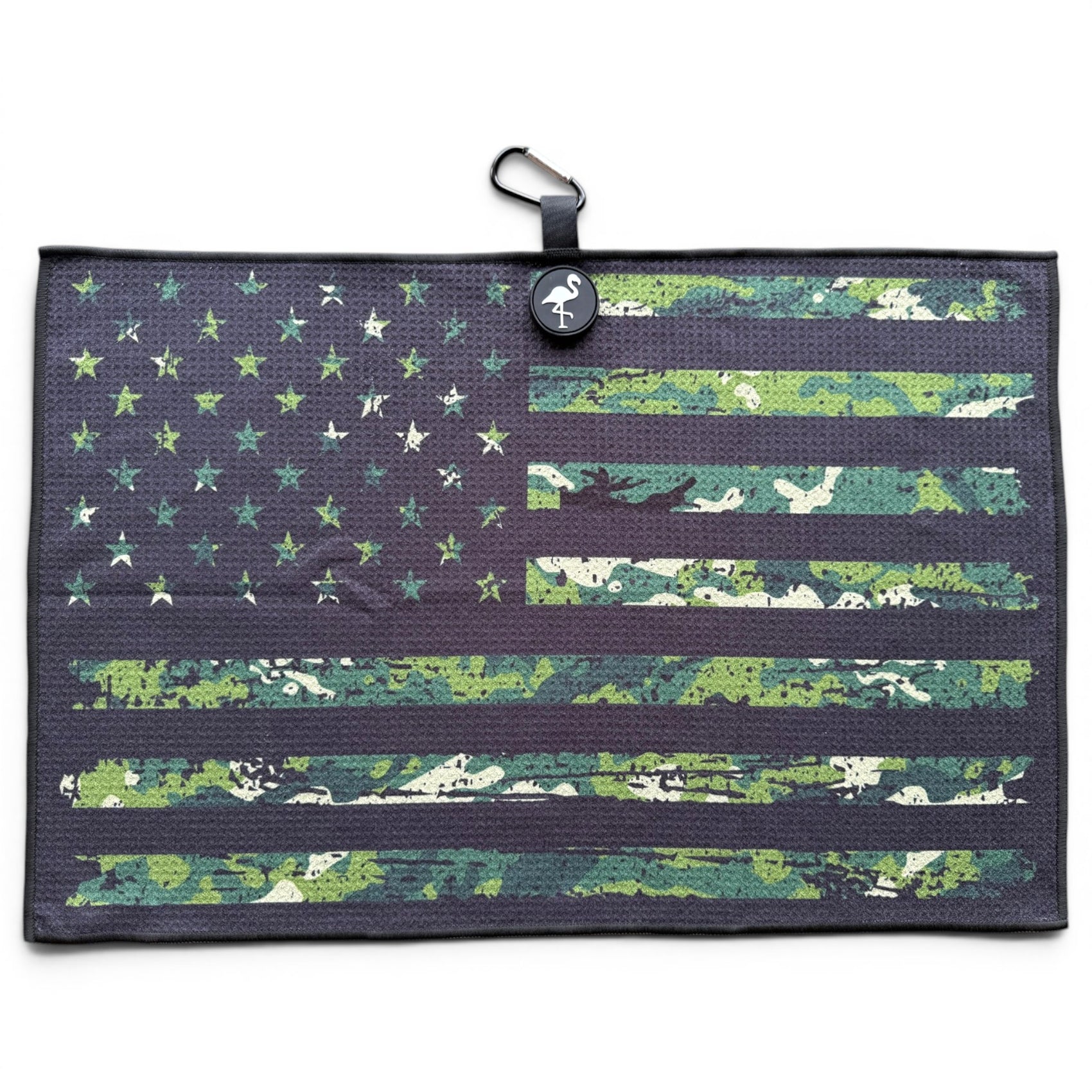 The Tactical Golf Towel is a 24” x 16” rectangular microfiber towel with a green camo and black American flag design, magnetic clip, carabiner, black hanging loop, and logo tag—perfect as a premium golf accessory.