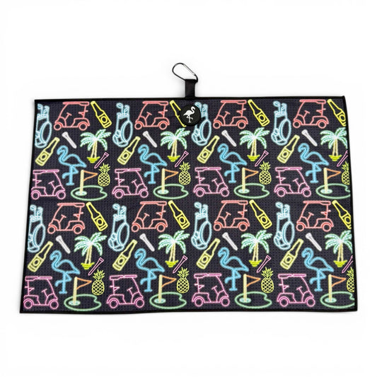 The Miami Slice Golf Towel is a 24 x 16 in premium double-sided microfiber towel, featuring a vibrant neon golf design on a black background. It includes a heavy-duty magnetic attachment and carabiner clip for easy hanging.