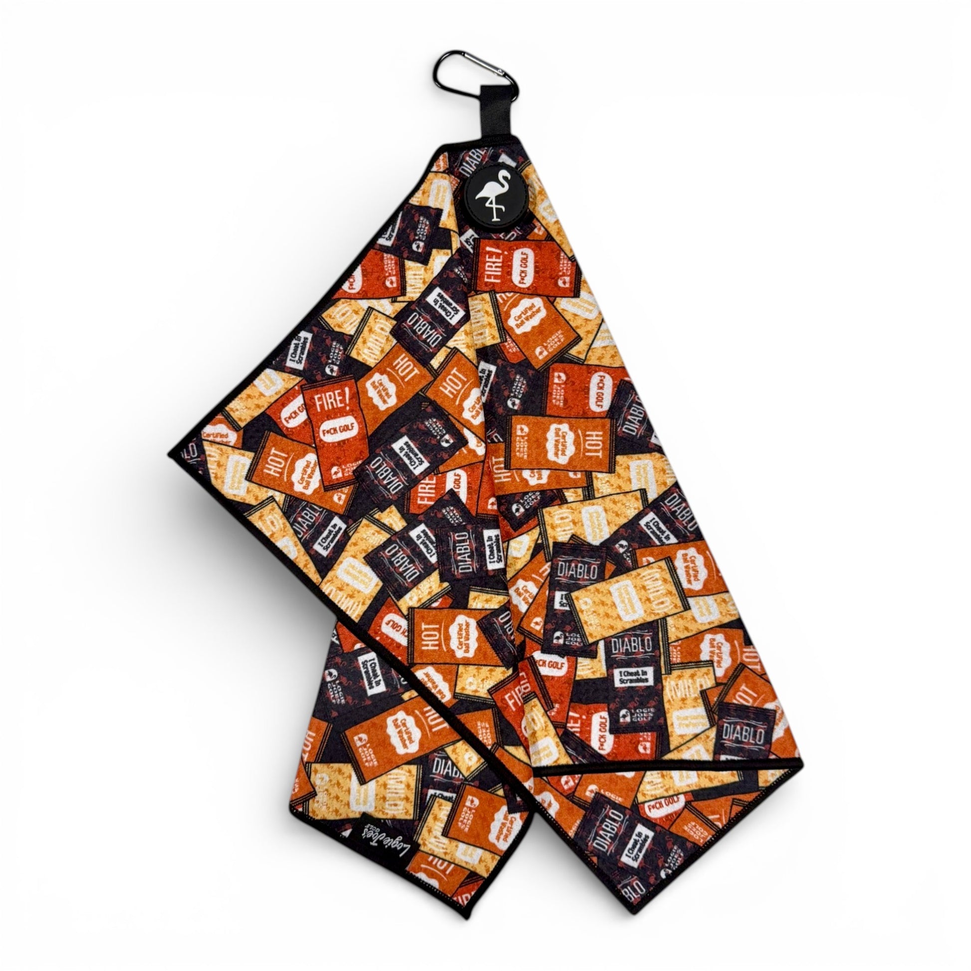 The Hot Sauce Golf Towel is a 24"x16" premium double-sided microfiber towel with heavy-duty magnet, carabiner clip, and a vibrant hot sauce packet print—perfect for style and cleaning on the course.