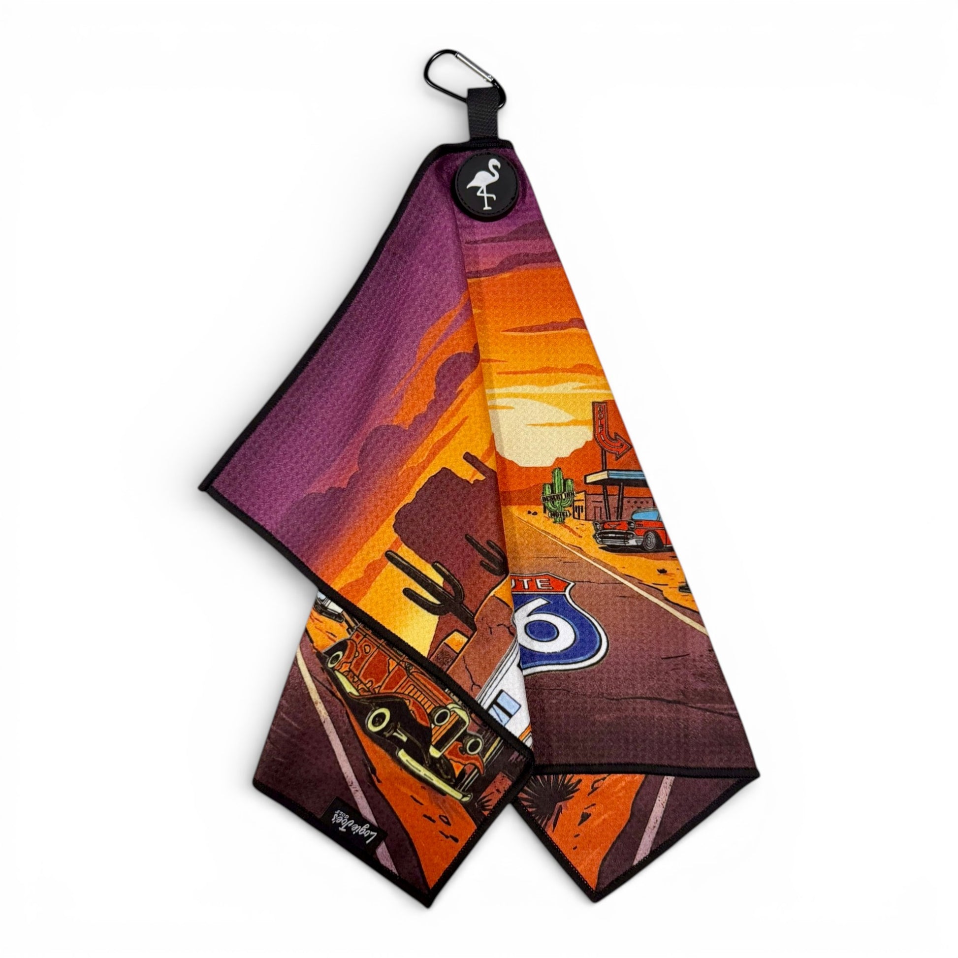 The Route 66 Golf Towel is a 24x16" premium double-sided microfiber towel with a magnetic carabiner clip, featuring a vibrant sunset highway design—perfect for fans of Americana golf accessories.