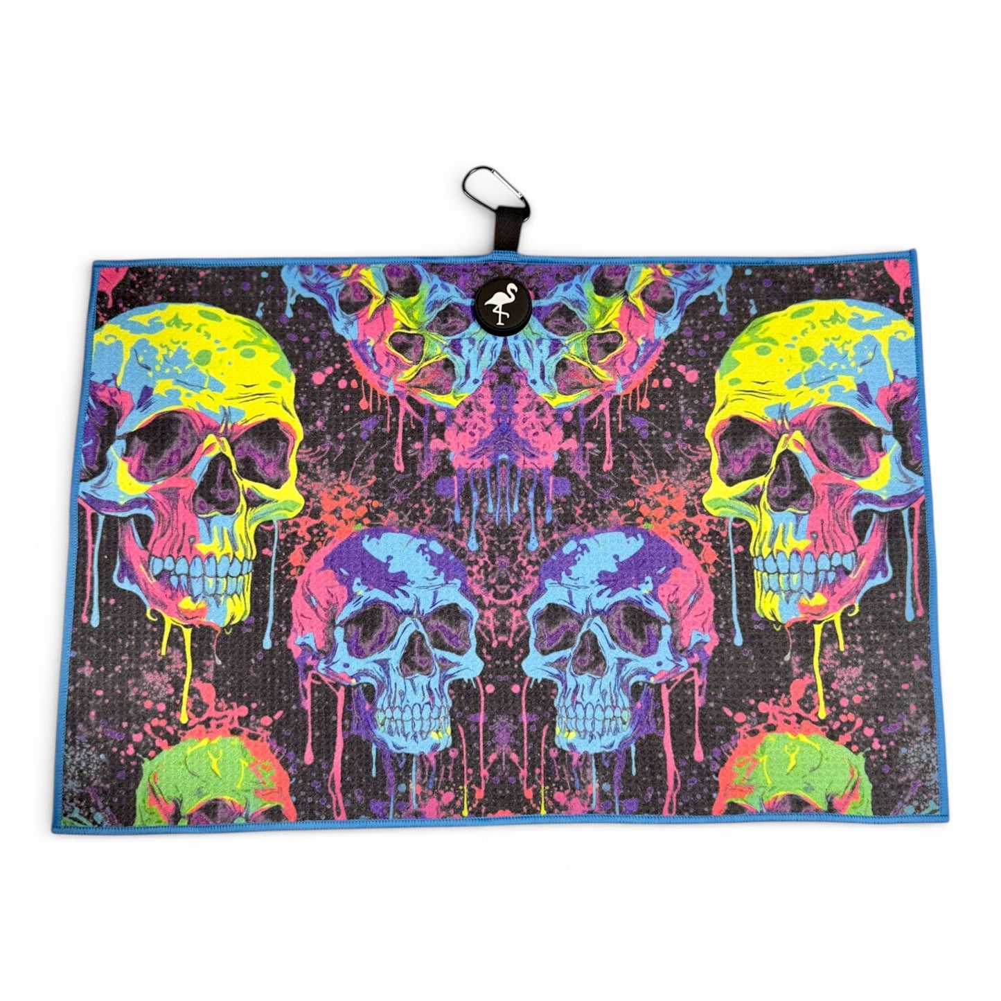 The Neon Skull Golf Towel features vibrant neon skulls with dripping paint on black, measures 24 x 16 in, and is crafted from premium double-sided microfiber. Includes a heavy-duty magnetic design and carabiner clip for easy attachment.