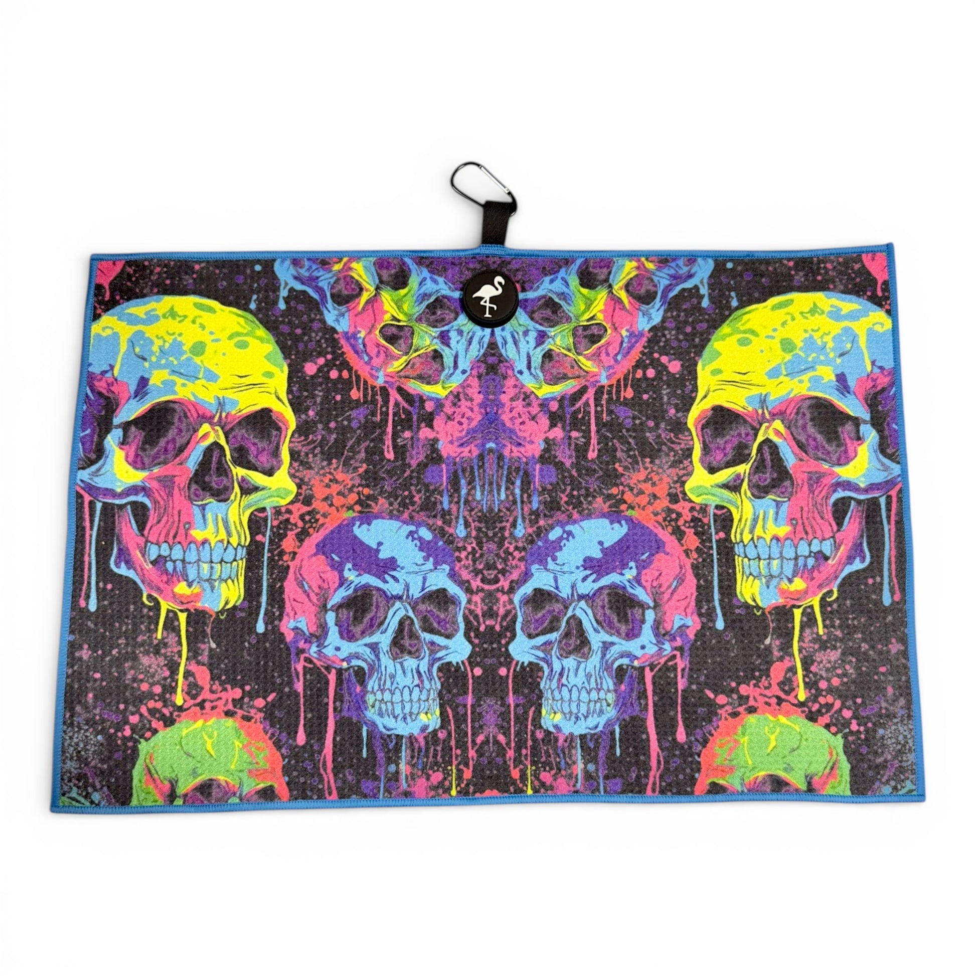 The Neon Skull Golf Towel features vibrant neon skulls with dripping paint on black, measures 24 x 16 in, and is crafted from premium double-sided microfiber. Includes a heavy-duty magnetic design and carabiner clip for easy attachment.