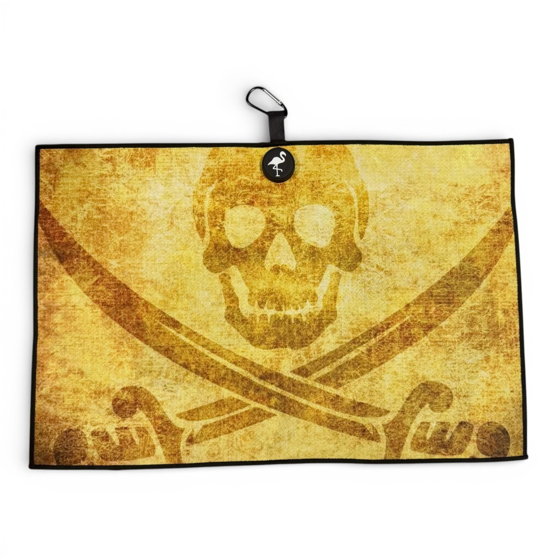 The Pirate Skull Golf Towel is a double-sided microfiber towel (24 x 16 in) featuring a brown skull and crossbones with crossed swords, a carabiner clip, heavy-duty magnetic backing, and a small flamingo icon attached to the top.