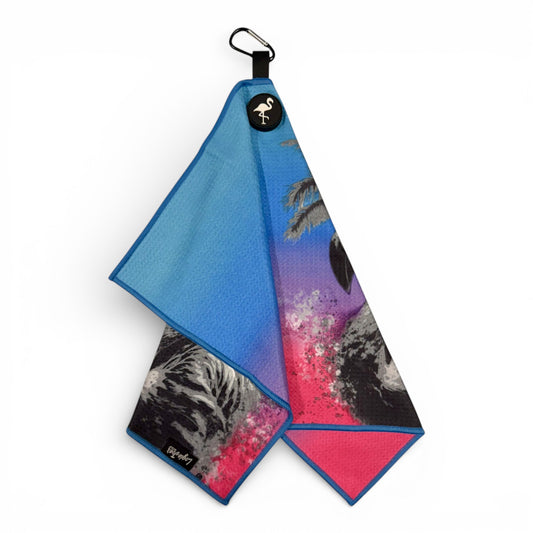 The Flamingo Palm Golf Towel features premium double-sided microfiber with vibrant prints, a blue reverse, pink and purple gradient, blue trim, a carabiner clip, and heavy-duty magnetic attachment—an essential 24 x 16 in golf accessory.