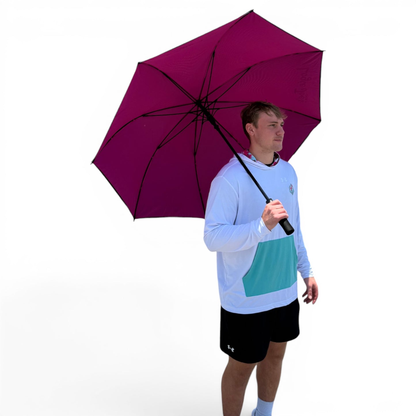 A man in a white and light blue long-sleeve shirt and black shorts stands holding the 60" Oversized Black & Pink Golf Umbrella, providing ample rain coverage, in front of a plain white background.