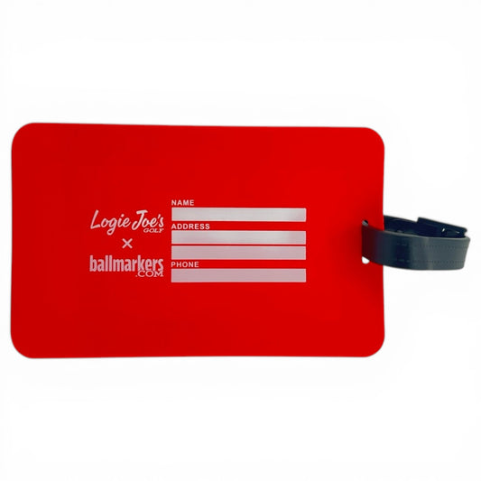 The 'Hello My Name Is' Clip-On Tag is a red rectangular bag tag with name, address, and phone fields, Logie Joes Golf x ballmarkers.com in white, and a black strap on the right—ideal as a golf or travel accessory.