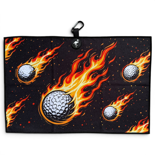 The Fireball Drive Golf Towel (24” x 16”) features black microfiber with flaming golf balls, plus a magnetic clip and carabiner for easy hanging—making it a premium, dynamic golf accessory.